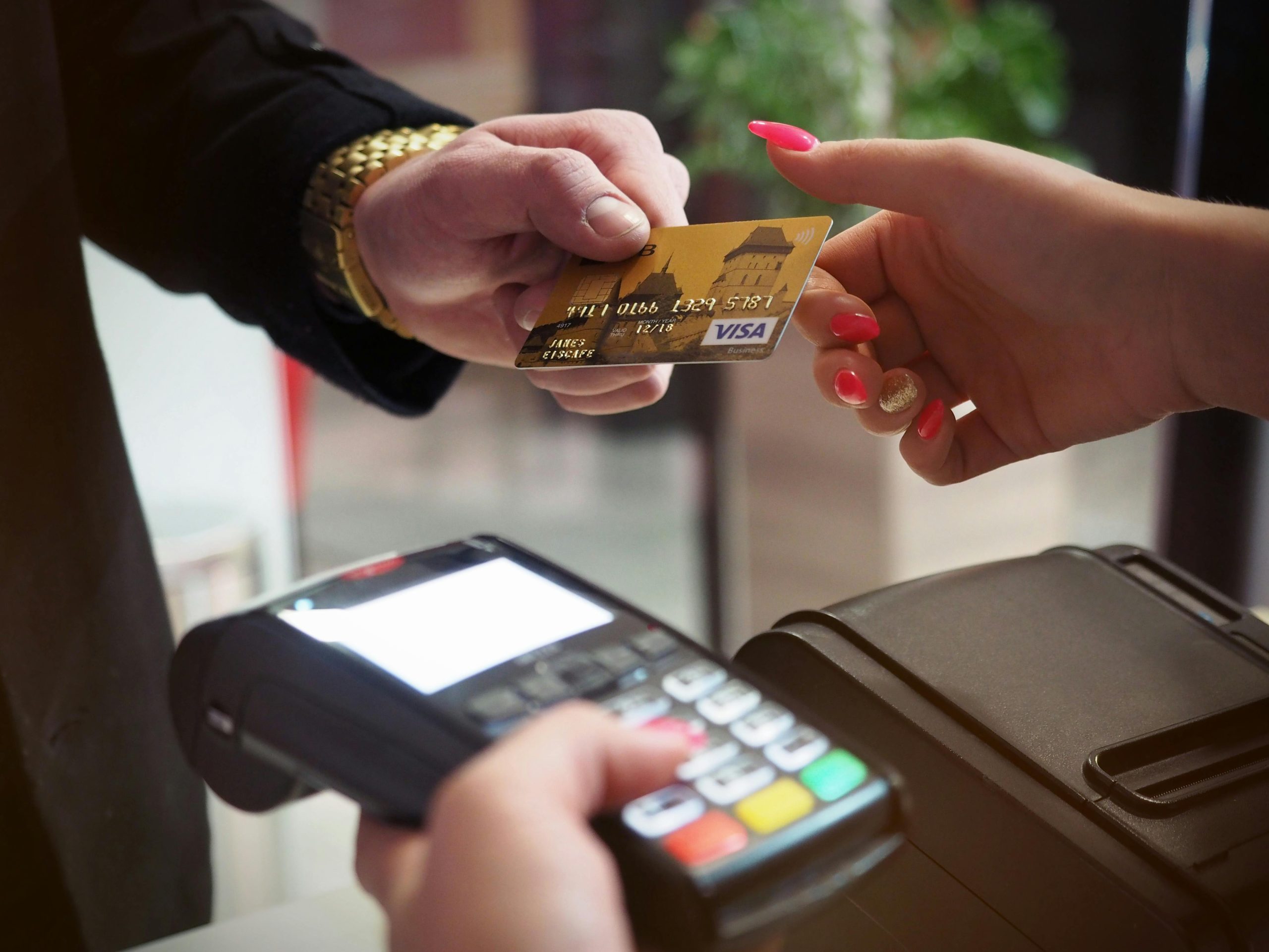 Conversion: Close-up of a credit card payment being processed at a POS terminal.